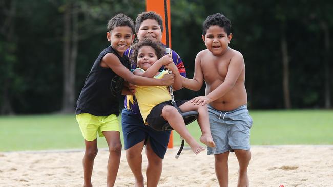 Cousins Sterling Fourmile, 6, Jykiele Burns, 8, and Keinie Burns-Kynuna, 6, push Tamar Paterson, 2 on the flying fox zip line at Todd Park in Bentley Park. Picture: Brendan Radke