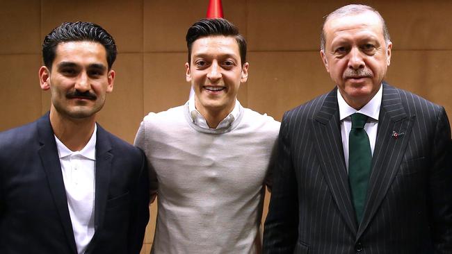 Turkish President Recep Tayyip Erdogan, right, poses with German footballers of Turkish origin Ilkay Gundogan, left, and Ozil. Picture: AFP