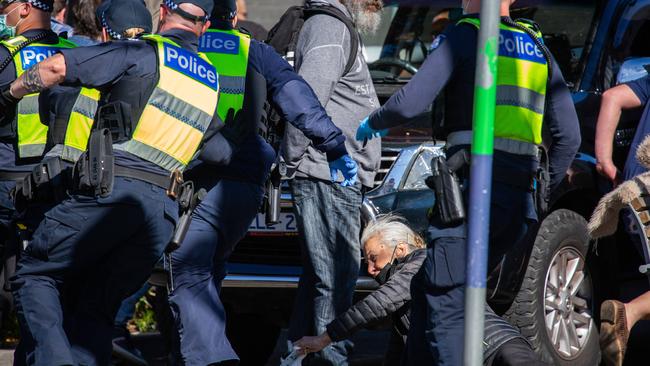 An elderly women on the ground after being knocked over by police as they chased protesters at Richmond. Picture: NCA NewsWire/Sarah Matray