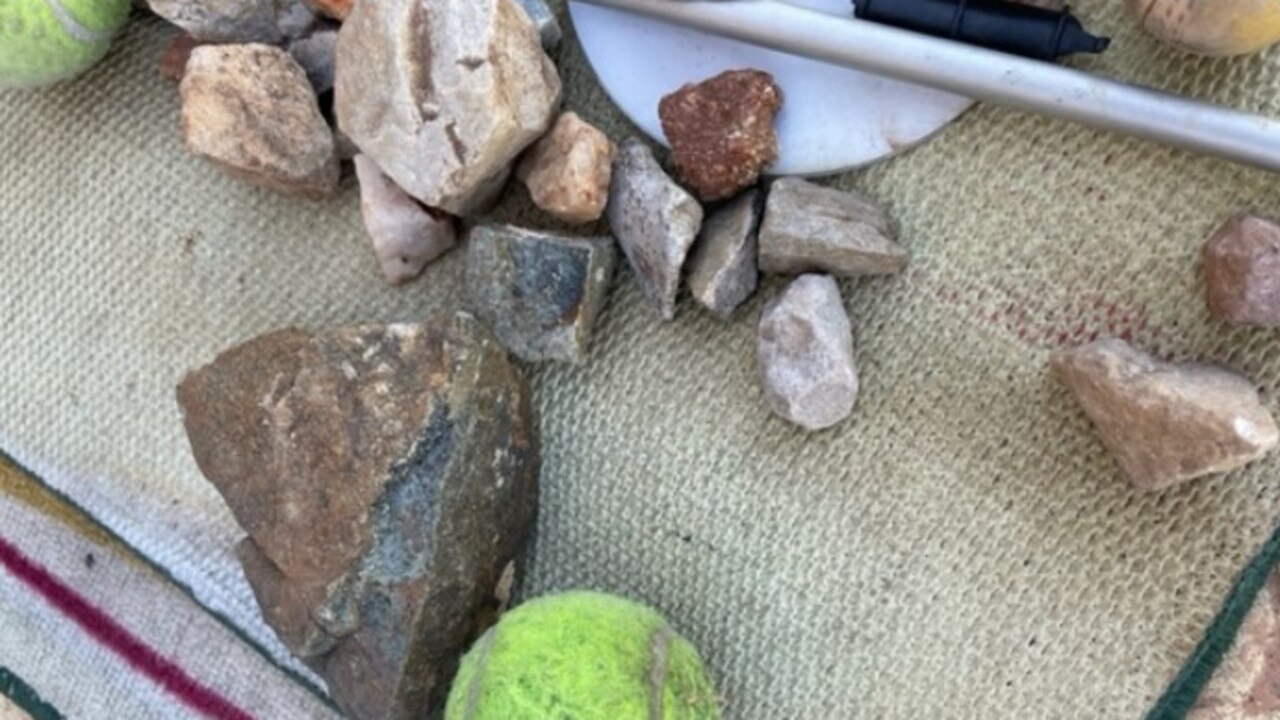 Rocks collected outside a residents house in Larapinta, Alice Springs. Namatjira MLA Bill Yan is calling for the Government to take a targeted approach to rock-throwing.