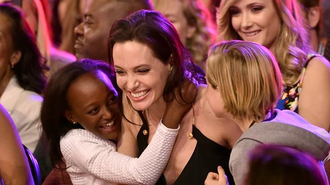 Actor Angelina Jolie hugs kids Zahara Marley Jolie-Pitt and Shiloh Nouvel Jolie-Pitt after winning a Nickelodeon Annual Kids' Choice Award last year. Picture: Kevin Winter/Getty Images