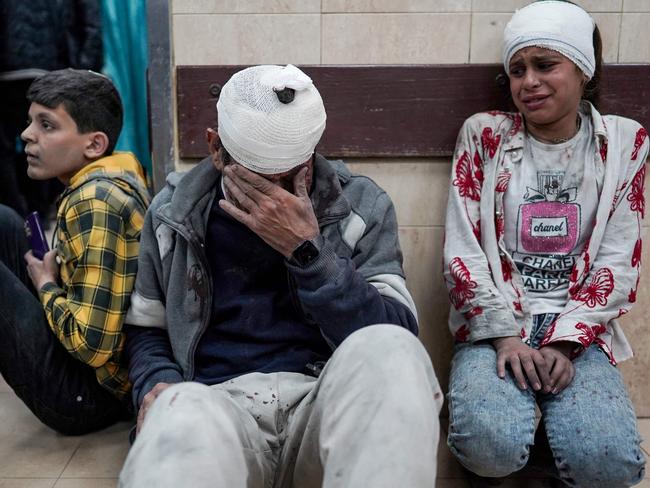 Palestinians injured during Israeli bombardment on the Nuseirat refugee camp in central Gaza, wait to receive medical treatment at al-Aqsa Hospital in Gaza. Picture: AFP