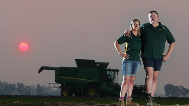 Peter and Renee Burke in their rice crop. Picture: Yuri Kouzmin