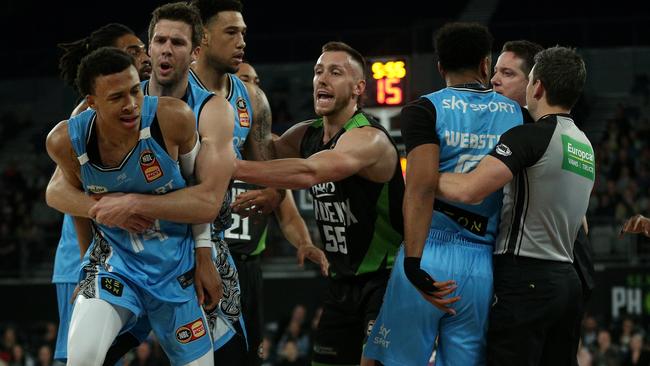 An incensed RJ Hampton of New Zealand (left) is restrained by teammate Tom Abercrombie in an incident that led to him being ejected against the Phoenix. Picture: AAP