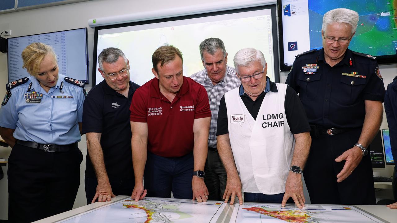 Queensland Police Commissioner Katarina Carroll, Senator Murray Watt, Deputy Premier Steven Miles, Queensland Local Government Minister Mark Furner, Cairns Mayor Terry James and Queensland Fire and Emergency Services Assistant Commissioner Brad Commens look over flood zone maps for the Cairns region at the Cairns Local Disaster Coordination Centre. Picture: Brendan Radke