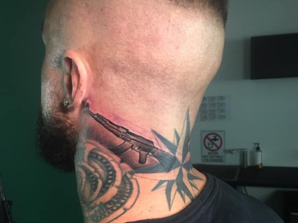 Zivko Stojakovic’s neck tattoo featuring an AK47.