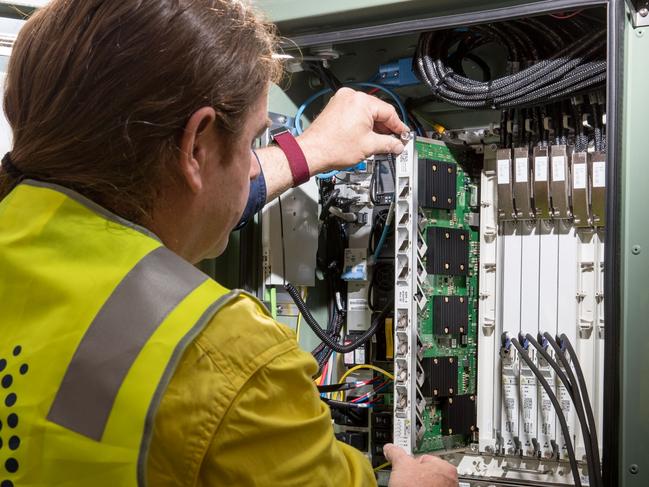 An NBN Co. technician handles hardware in a fiber distribution cabinet during the installation of fiber-to-the-building connections in Sydney, Australia, on Tuesday, Oct. 3, 2017. NBN says it's aiming to increase annual revenue more than five-fold to A$5.4 billion and be cash flow positive in 2021. Photographer: Cole Bennetts/Bloomberg