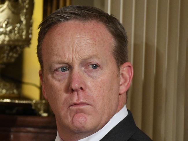 White House Press Secretary Sean Spicer looks on as US President Donald Trump speaks during a joint press conference with Colombia's President Juan Manuel Santos at the White House on May 18, 2017 in Washington, DC. / AFP PHOTO / JIM WATSON