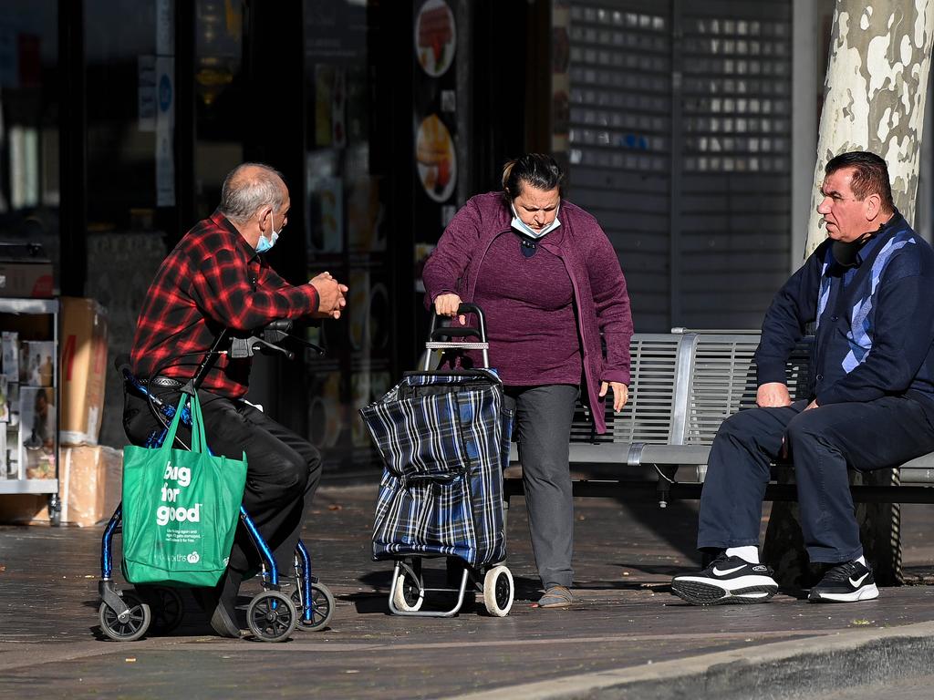 Locals outside a shop in Fairfield. Picture: NCA NewsWire/Bianca De Marchi \\