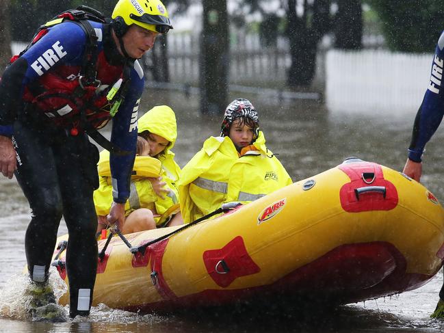 Rochelle Wright and her kids Amelia, 1, and William, 5, are evacuated from their house in Raymond Terrace. Picture by Peter Lorimer.