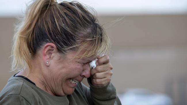 Edie Hallberg cries while speaking to police outside a Walmart store where a shooting occurred earlier in the day as she looks for her missing mother Angie Englisbee. Picture: AP