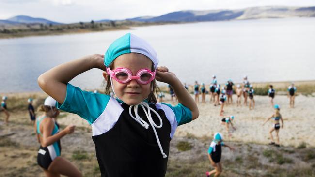 Despite its distance from the ocean, Jindabyne’s 60-odd Yabbies train in the dam’s cool, fresh waters. They are linked to Tathra on the NSW south coast and visit to compete in surf carnivals a couple of times a year. Picture: Frances Mocnik