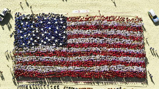 Gold Coast, September 11, 2002. Over 3000 Gold Coast residents, firemen and police gathered on Surfers Paradise beach to form the flag of the United States of America, in commemoration of the September 11 terrorist attacks a year earlier. (AAP Image/Dave Hunt)