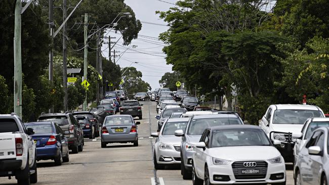 Long line of cars waited to get tested for COVID-19 at the Inner West Council Works Depot in Summer Hill on Wednesday. Picture: Adam Yip