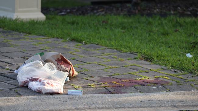 A bloodied shopping bag in the driveway of the Elm Rd home where Aleksandra Vergulis and Daniela Vergulis were allegedly shot. Picture: Russell Millard