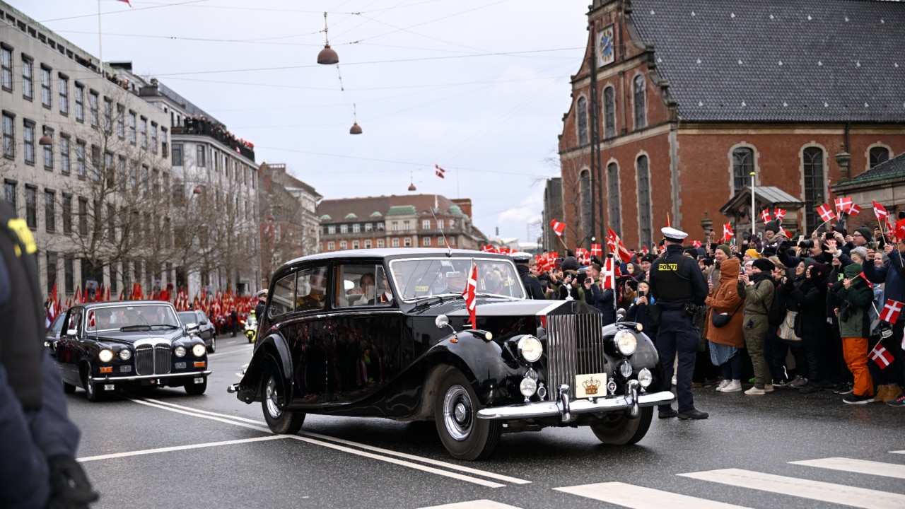 Frederik and Mary look onto excited crowds as they head to Christiansborg Palace