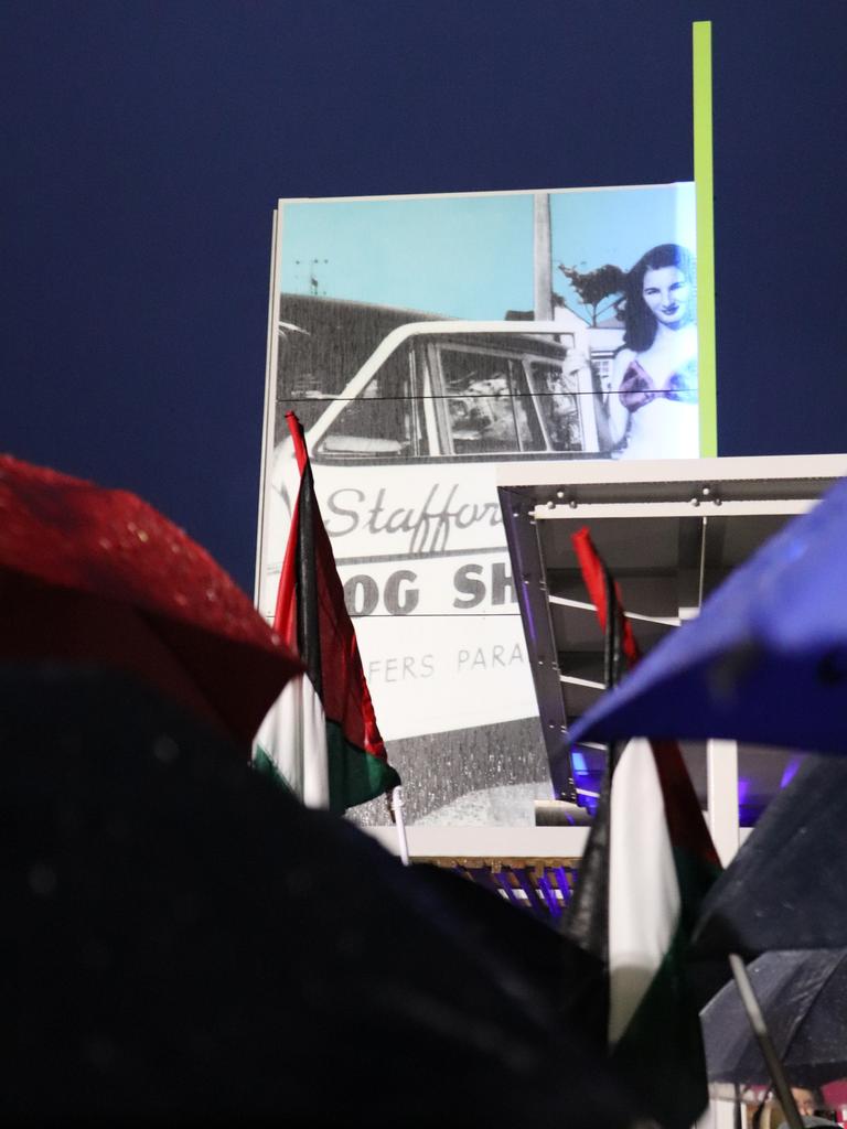 Protesters gathered at Surfers Paradise Esplanade despite torrential rain to call for an immediate ceasefire of bombing in the Gaza Strip. Picture: Amaani Siddeek