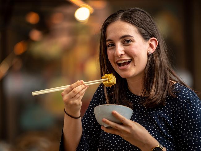 Sarah Puglisi enjoying fresh steamed pork and prawn shumai dumplings at Mama Mulan. Picture” Monique Harmer