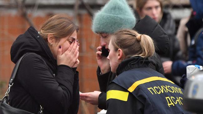 A woman is consoled at the scene of Wednesday’s helicopter crash in Brovary. Picture: AFP