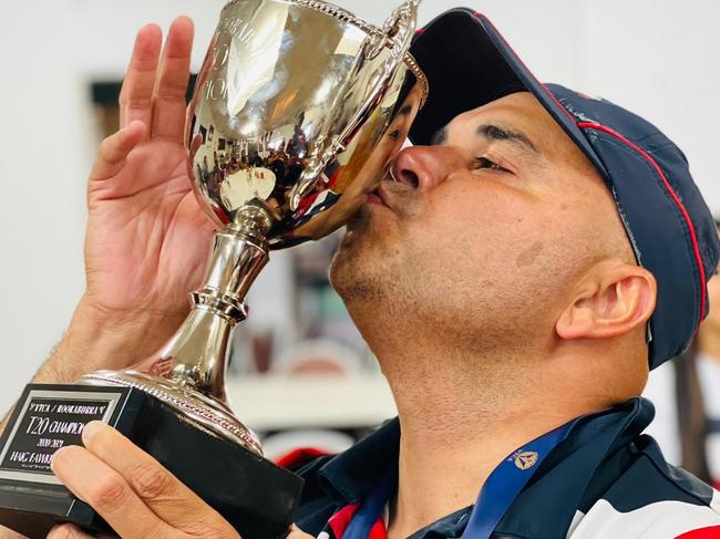 Haig Fawkner’s Amit Chaudhary kisses the VTCA T20 trophy. Picture: Haig Fawkner CC