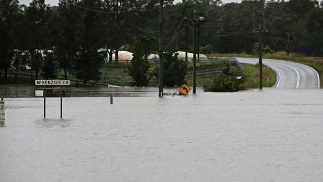 McKenzies creek flooded over Pitt Town Rd today. Picture: Adam Yip