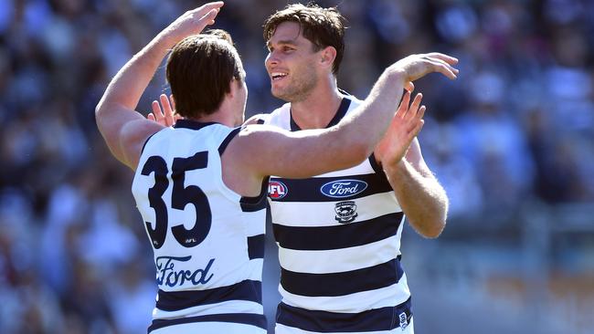 Tom Hawkins and Patrick Dangerfield celebrate a goal.