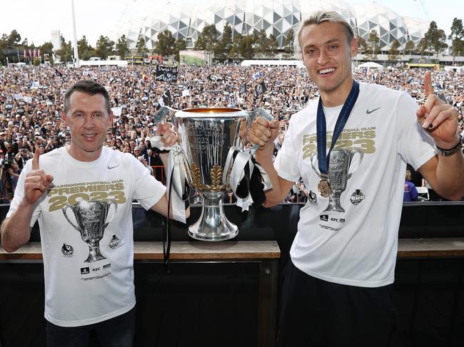 MELBOURNE , AUSTRALIA. October 1, 2023. AFL . The day after.. Collingwood family day at Olympic Park. Coach Craig McRae and captain Darcy Moore hold up the premiership cup infront of the Magpie army .Picture by Michael Klein