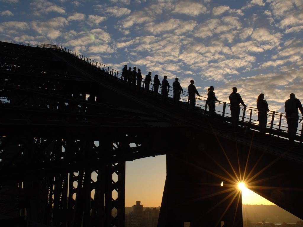 Climbers on the Harbour Bridge at dawn. Picture: BridgeClimb