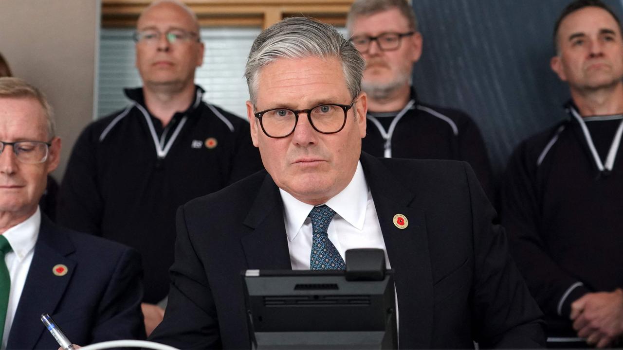 Britain's Prime Minister Keir Starmer looks on as he discusses over the phone a UK-US trade deal with US President Donald Trump at a car factory in the West Midlands, central England on May 8, 2025. (Photo by Alberto Pezzali / POOL / AFP)