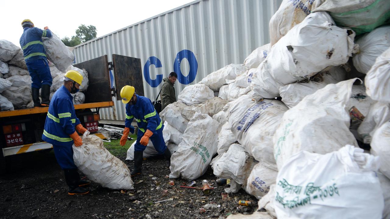 Nepali workers load sacks of waste collected from Mount Everest for recycling, in Kathmandu. Picture: Prakash Mathema/AFP