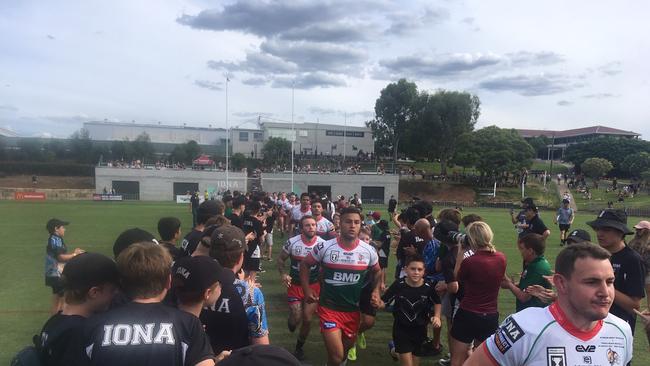 Iona College and Wynnum Meninga Cup players form a guide of honour for the Seagulls Intrust Cup side.