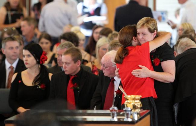 A woman hugs Denise Morcombe (right) as her son Bradley (centre) looks on during the funeral service for their son and brother Daniel Morcombe at St Catherine of Siena Catholic Church at Sippy Downs on the Sunshine Coast, Friday, Dec. 7, 2012. It is nine years to the day on which Daniel, who was 13 at the time, was kidnapped and murdered while waiting for a bus on the Sunshine Coast in 2003. (AAP Image/Sunshine Coast Daily, Brett Wortman, Pool) NO ARCHIVING. Picture: Brett Wortman