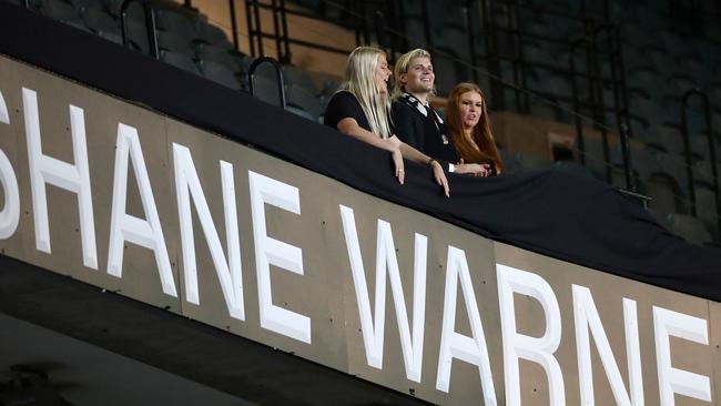 Brooke, Jackson and Summer Warne unveil the Shane Warne Stand during the State Memorial service for the former Australian cricketer at the MCG. Picture: AFP