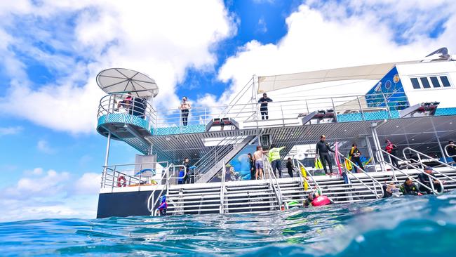 Tourists enjoying the reef from the $7 million Reef Magic pontoon at Moore Reef, off Cairns. Picture: Tourism and Events Queensland