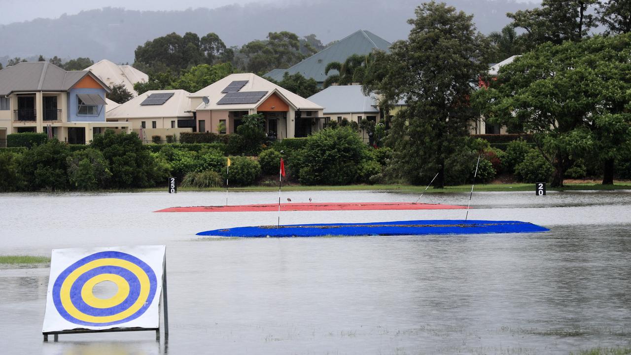 Emerald Lakes Golf Club and driving range at Carrara are swamped by floodwaters. Picture: NCA NewsWire / Scott Powick