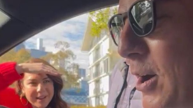 Ben Fordham driving an Uber, with Kate Ritchie looking through the car window. Photo: Supplied