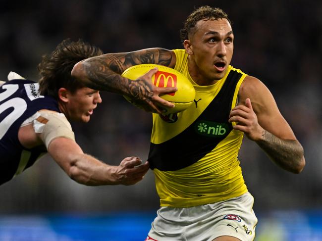 PERTH, AUSTRALIA - JUNE 10: Shai Bolton of the Tigers dodges a tackle during the 2023 AFL Round 13 match between the Fremantle Dockers and the Richmond Tigers at Optus Stadium on June 10, 2023 in Perth, Australia. (Photo by Daniel Carson/AFL Photos via Getty Images)