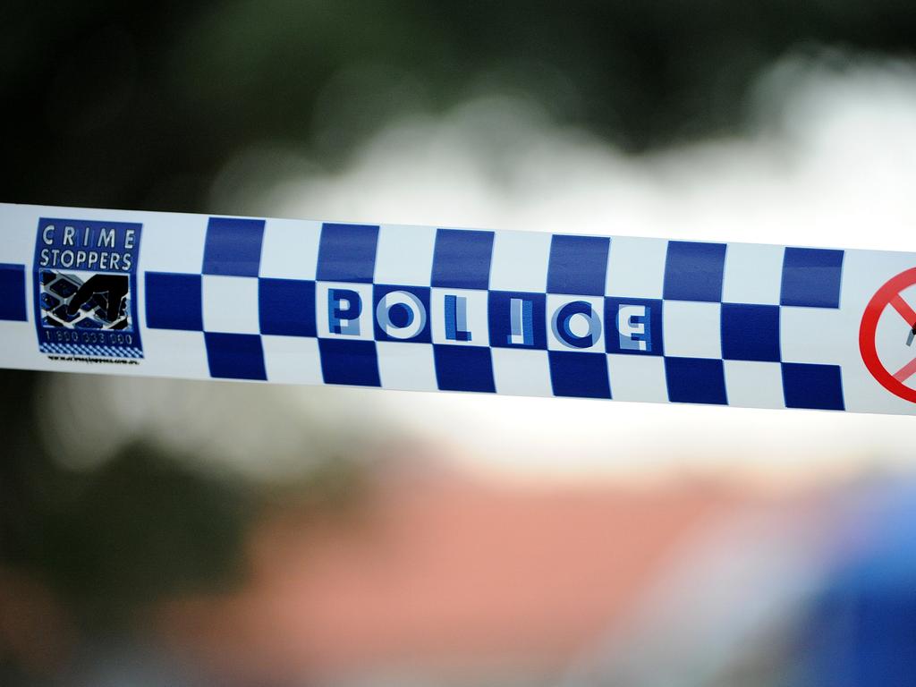 Police tape outside a home where a six week-old girl was found dead in a house in Newcastle, Friday, July 24, 2015. (AAP Image/Joel Carrett) NO ARCHIVING