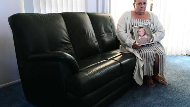 Janet Clarke holds a portrait of Stacey-Ann Tracy who was murdered 30 years ago in Roma. Picture: Mike Knott