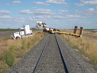 Truck comes to rest across railway lines beside the Warrego Hwy at Macallister, about 10km west of Dalby, on January 15, 2014. :Photo Geoff Lapthorne. Picture: Geoff Lapthorne