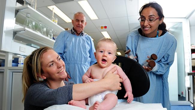 Four-month-old Imanuel Winter, with his mum Jean, will try his best to help out Flinders poo researchers Professor Graeme Young and Dr Geetha Gopalsamy. Picture: Mark Brake