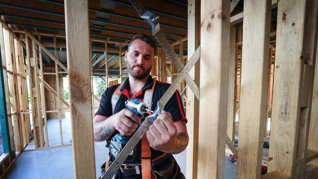 Tradies work on a Metricon building site, pictured is carpenter Luke Marchetti. Picture: David Caird