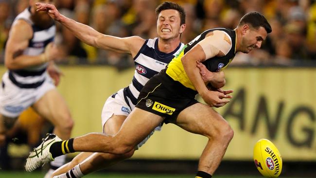 Richomnd’s Jack Graham is tackled by Geelong’s Jack Henry. Picture: Michael Willson/Getty