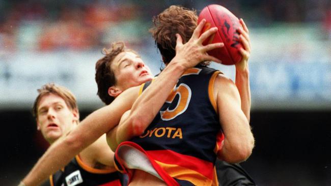 Day to forget ... Richmond's Ben Holland captures more than the ball as he gathers in David Pittman at the MCG in April, 1997.