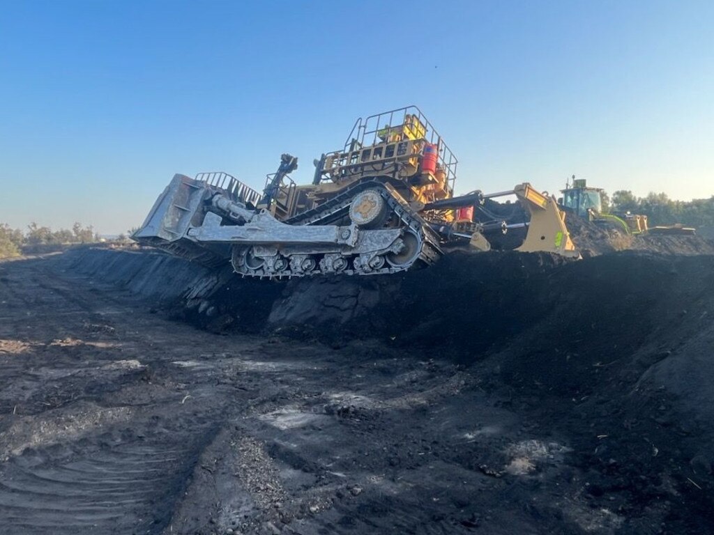 A dozer in the mud at Peak Downs days after two trucks slid more than 100m each.