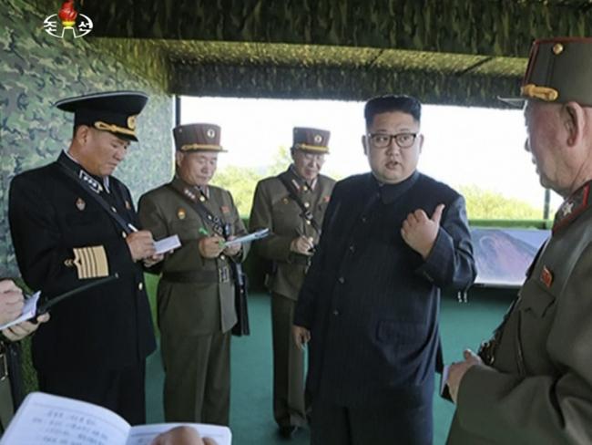 A photo of North Korean leader Kim Jong Un, second right, speaks with officials during what Korean Central News Agency called a "target=striking contest" at unknown location in North Korea. Picture: KRT via AP