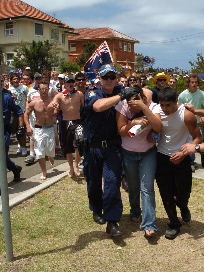 An angry mob chases four young people at North Cronulla, as police try to protect them from the crowd. Picture: Craig Greenhill