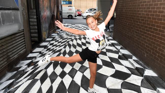 Penny Pantoulis, 12, of Bentleigh dances on street art in Strachan Lane by Archibald Prize winner Vincent Fantauzzo. Picture: Josie Hayden.