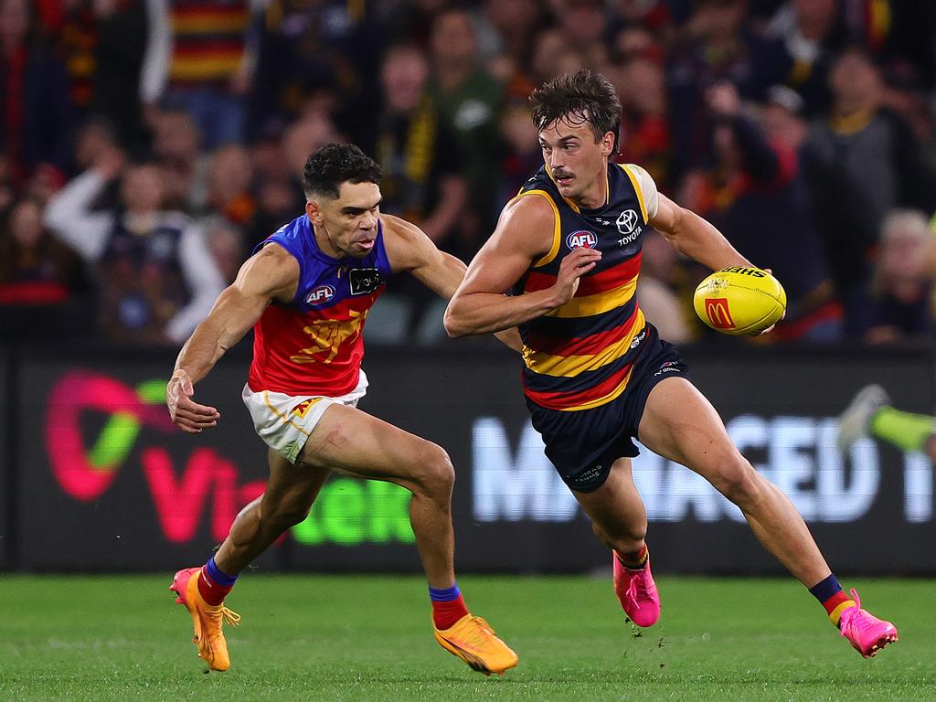 Luke Nankervis dashes away from Charlie Cameron. Picture: Sarah Reed/AFL Photos via Getty Images