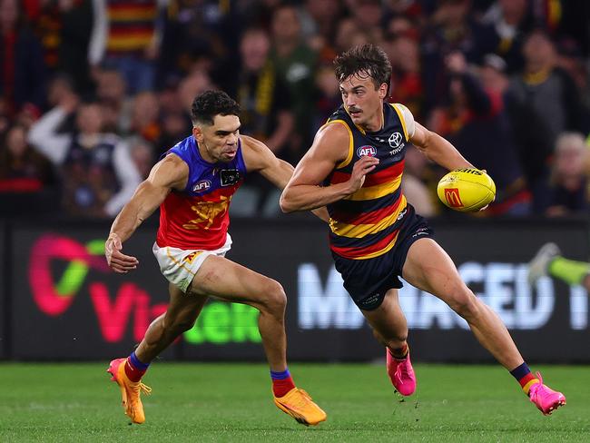 Luke Nankervis dashes away from Charlie Cameron. Picture: Sarah Reed/AFL Photos via Getty Images